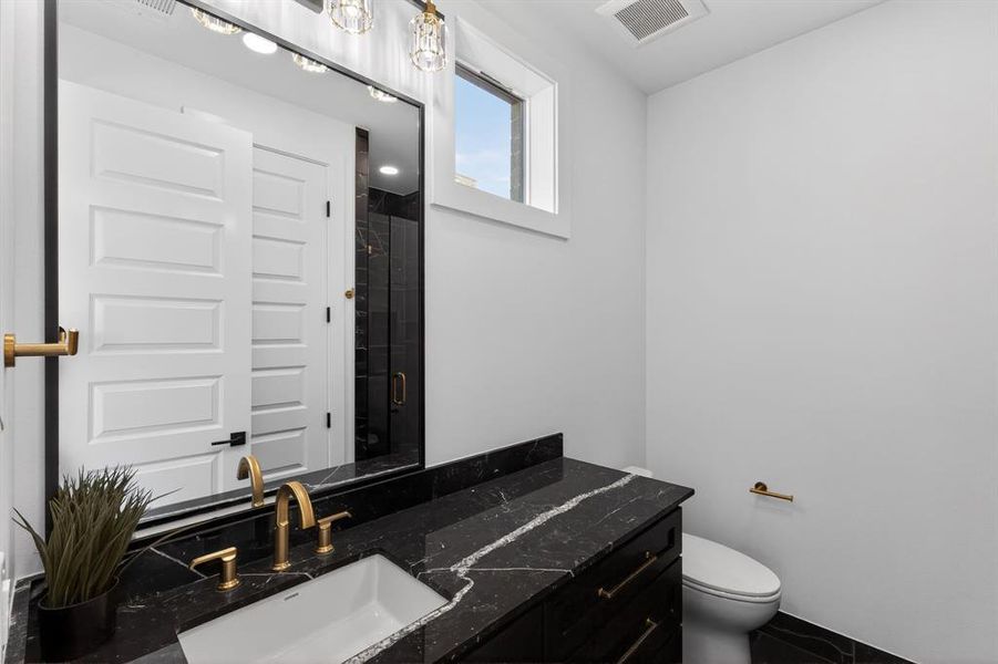 Full bath with a stall shower and vanity