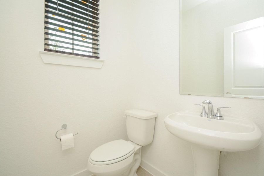 Functional half bath perfectly located for guests. Functional half bath perfectly located for guests.