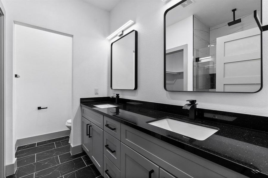 THe primary ensuite bathroom has double sinks and lots of stroage space