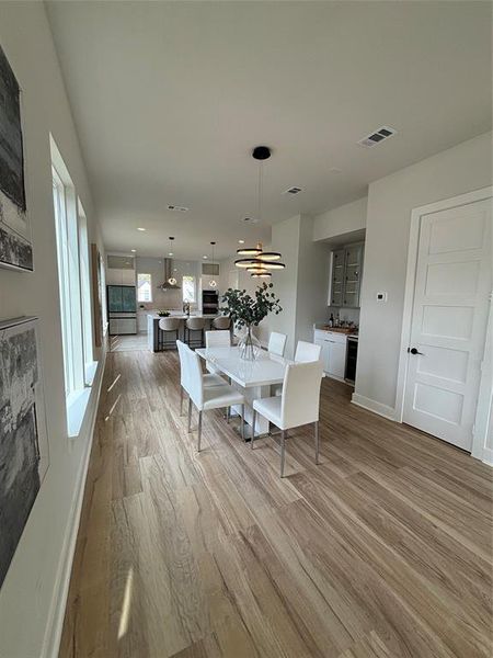 Dining space featuring light wood-style flooring and baseboards