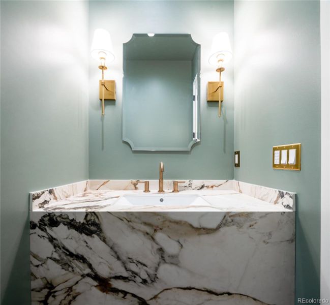 Main floor powder room with custom porcelain, floating vanity