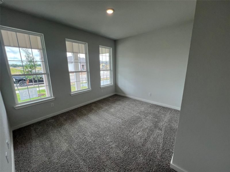 Three well-placed windows naturally illuminate this versatile bonus room.