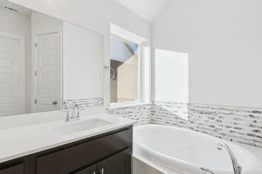 Bathroom featuring a garden tub and vanity Bathroom featuring a garden tub and vanity