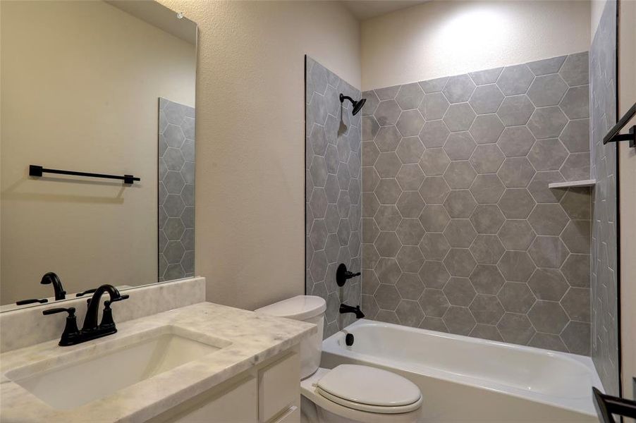 Bathroom with shower / tub combination and vanity