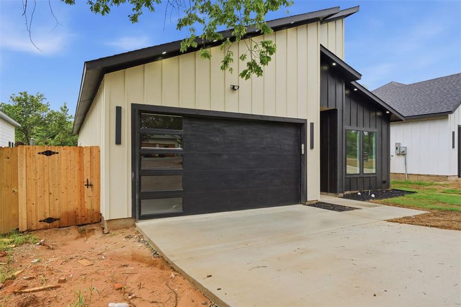 Contemporary exterior design featuring a steeply pitched roofline and vertical siding