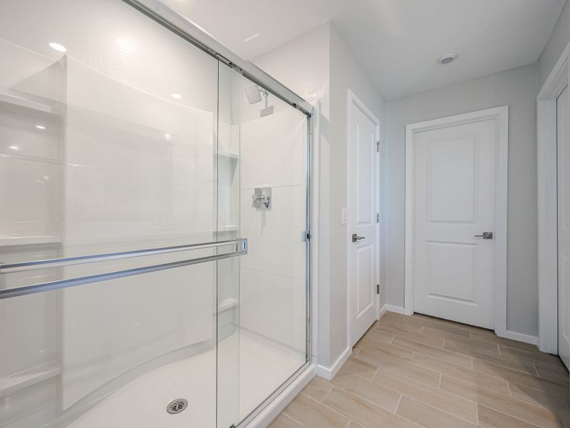 A bathroom with a glass shower. A bathroom with a glass shower.