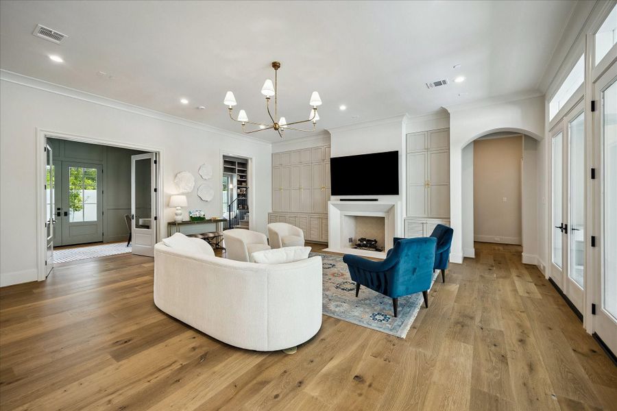 From this angle, the thoughtfully designed layout comes into focus, with the fireplace and custom millwork creating a sophisticated focal point. The open flow connects seamlessly to adjacent spaces, while the scale of the room allows for both intimate seating and effortless entertaining.