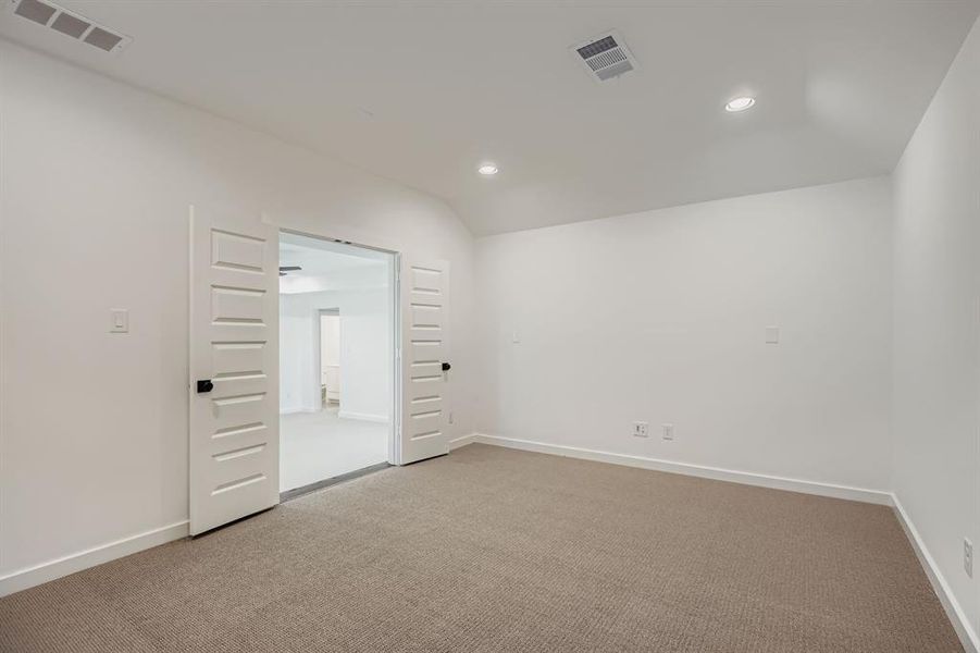 Empty room with recessed lighting, light colored carpet, and lofted ceiling