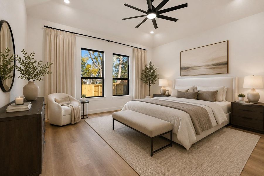 The primary suite, conveniently located on the first floor, showcases 11-foot ceilings, recessed lighting, and an exceptional en-suite retreat. (Virtually Staged)