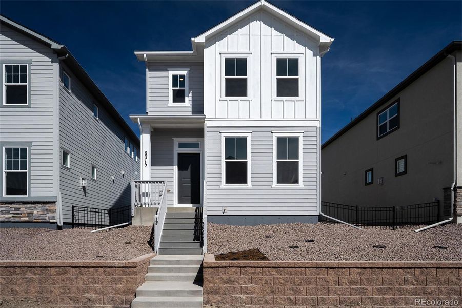 Exterior details and patio area of a home in Revel Crossing at Wolf Ranch – The Ascent Collection, Colorado Springs (Image 2).