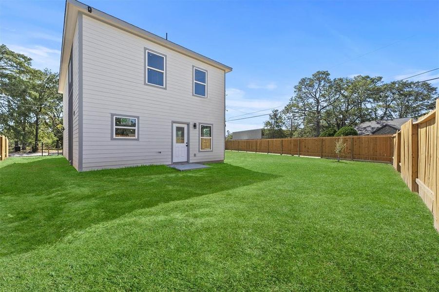 Fully fenced backyard with driveway gate