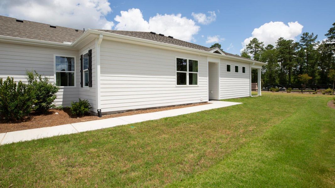 Representative exterior photo of a completed home built from the TUSCAN II by D.R. Horton in Indigo Preserve Townhomes, Leland, NC (Image 20).