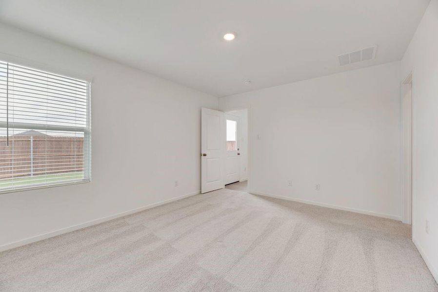 Spare room featuring light colored carpet and recessed lighting