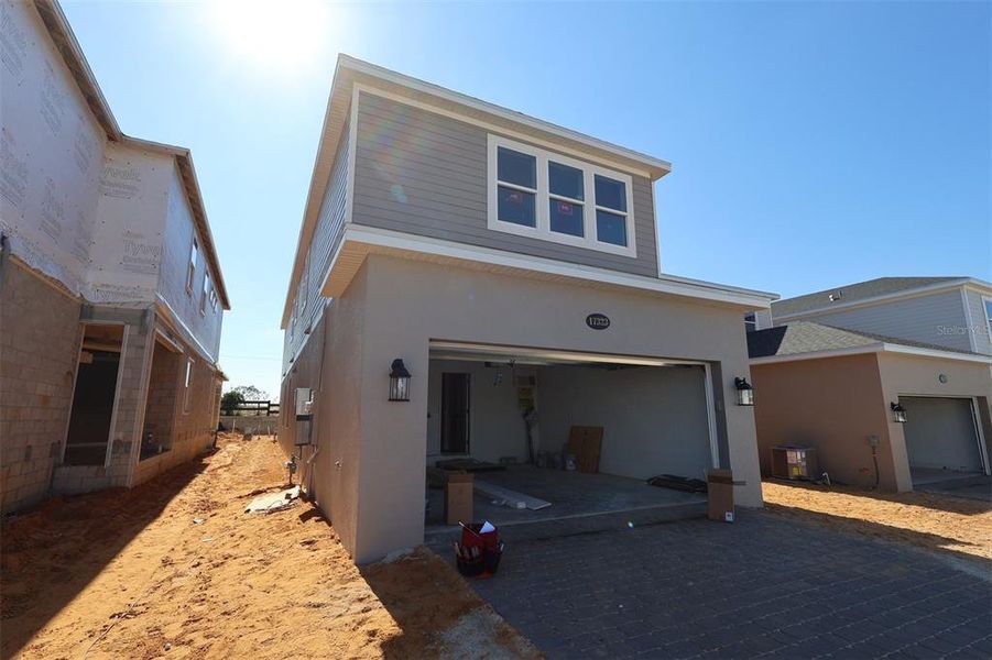 In-progress construction of a new home in Lake Star at Ovation, Winter Garden, FL (Image 12).