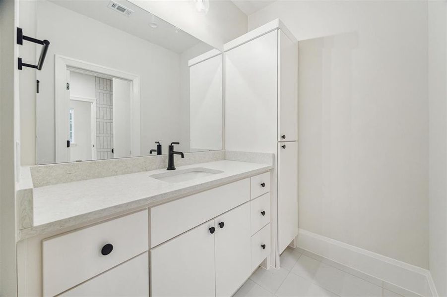 Two of the secondary bedroom share a jack and jill bath with separate vanity areas