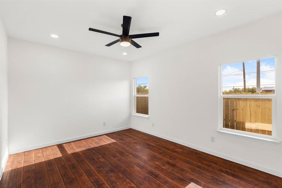 Spare room featuring hardwood / wood-style flooring and ceiling fan