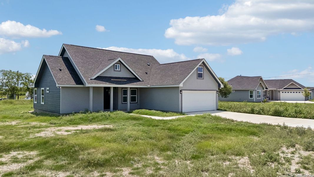 Front exterior of a new home in , Natalia, TX, highlighting curb appeal (Image 20).