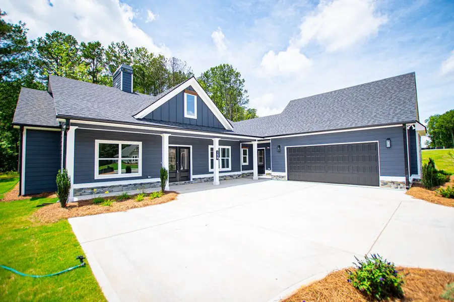 Front exterior of a new home in WOODMONT RESERVE, Roopville, GA, highlighting curb appeal (Image 37).