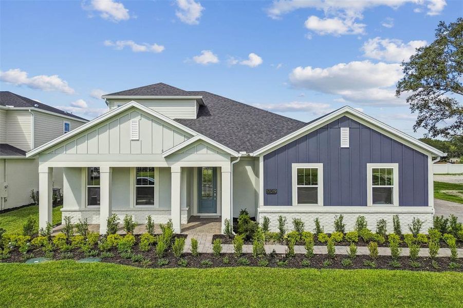 Front exterior of a new home in Solace at Corner Lake, Orlando, FL, highlighting curb appeal (Image 28).