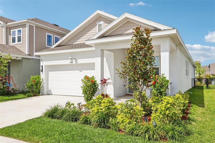 Front exterior of a new home in Waterset Garden Series, Apollo Beach, FL, highlighting curb appeal (Image 26).