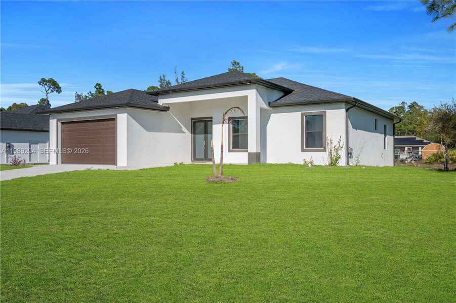 Front exterior of a new home in , Lehigh Acres, FL, highlighting curb appeal (Image 23).