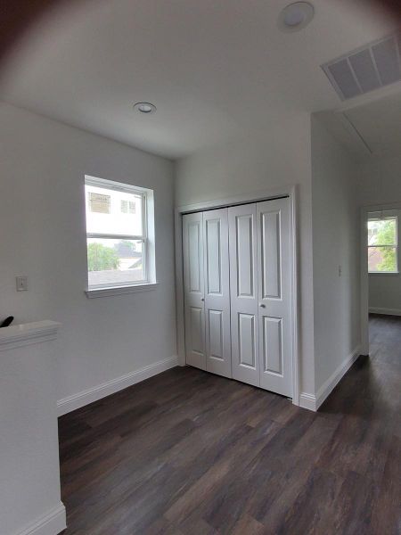 Laundry locatd in the very bright hallway