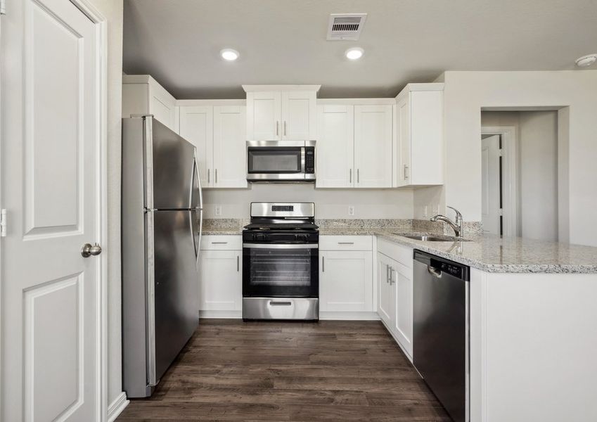 Chef-ready kitchen with granite countertops and white cabinets Chef-ready kitchen with granite countertops and white cabinets