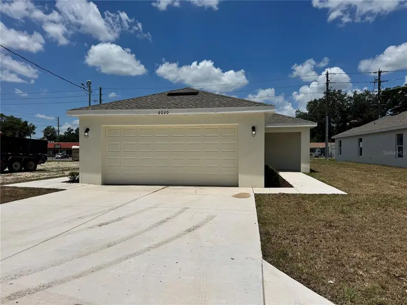 Front exterior of a new home in , Zephyrhills, FL, highlighting curb appeal (Image 2). Front exterior of a new home in , Zephyrhills, FL, highlighting curb appeal (Image 2).