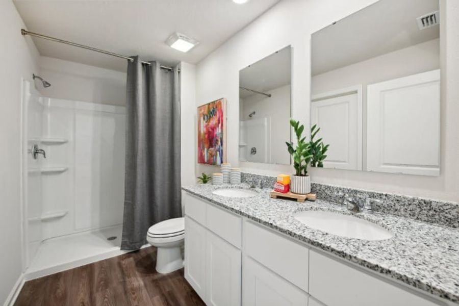 A bathroom with a tub sink and toilet. A bathroom with a tub sink and toilet.
