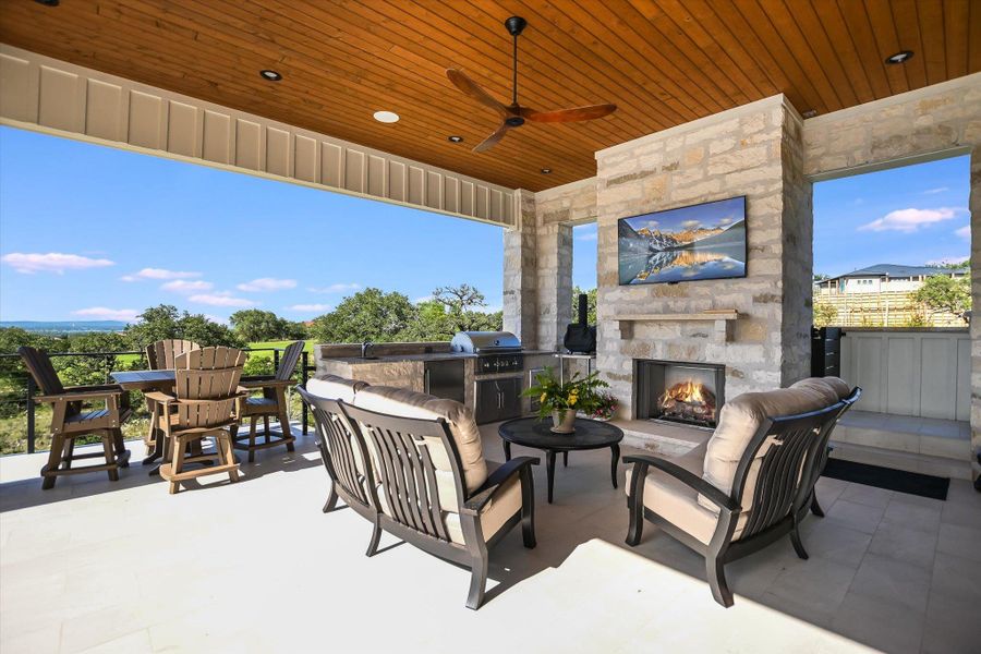 View of patio featuring ceiling fan, an outdoor living space with a fireplace, and a sink View of patio featuring ceiling fan, an outdoor living space with a fireplace, and a sink