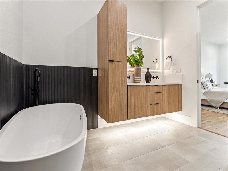 Bathroom featuring a bath, hardwood / wood-style flooring, and vanity