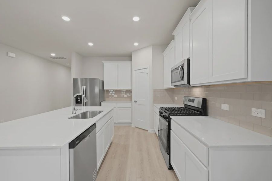 A kitchen with white cabinets. A kitchen with white cabinets.