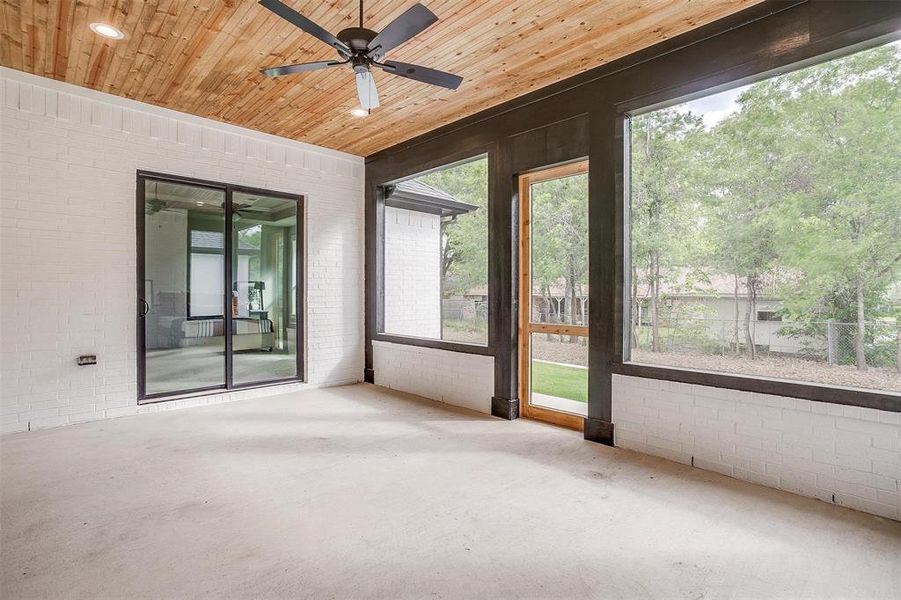 Unfurnished sunroom featuring a ceiling fan Unfurnished sunroom featuring a ceiling fan