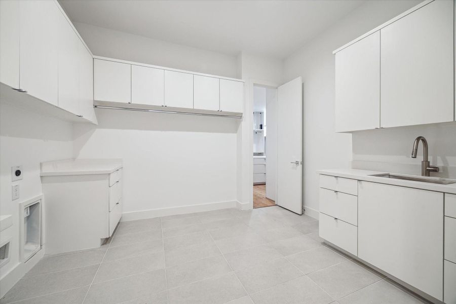 Large utility room with plenty of storage and sink