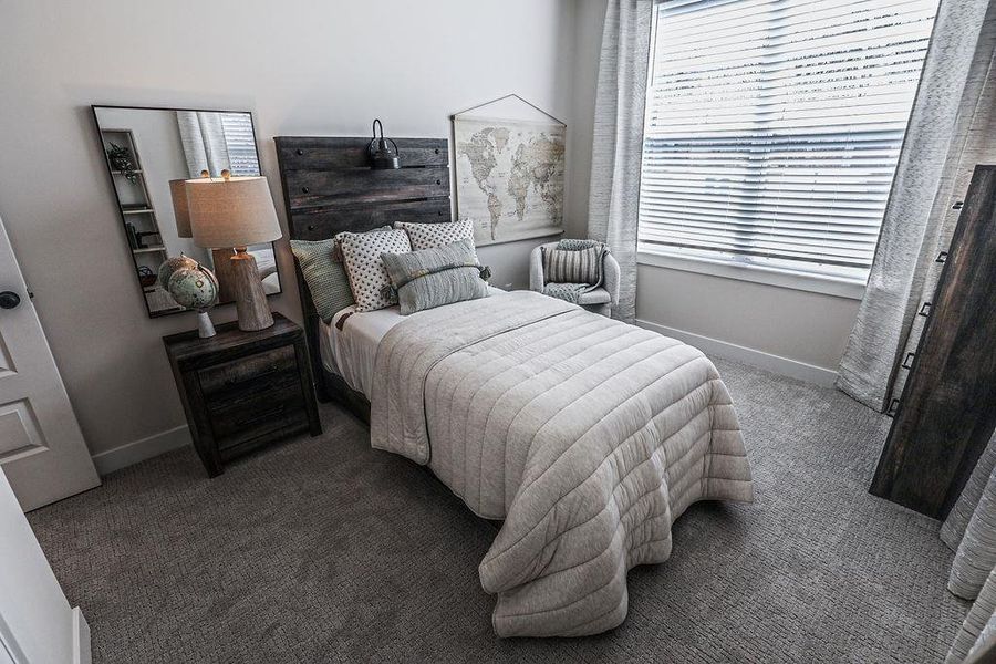 Carpeted bedroom with baseboards