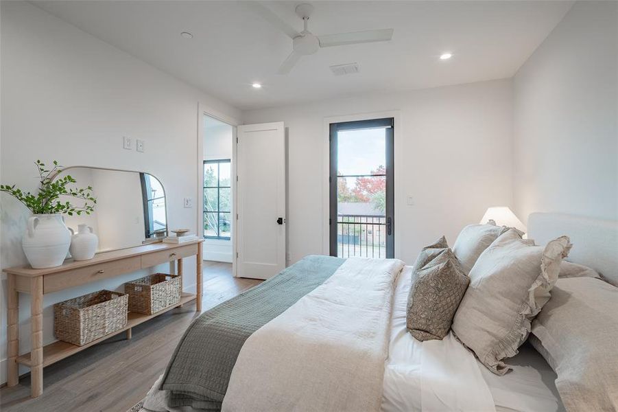 Bedroom featuring hardwood / wood-style flooring, ceiling fan, and access to exterior