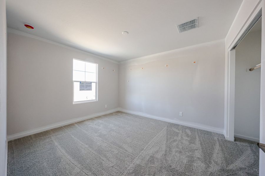 A room with a carpet and a window. A room with a carpet and a window.