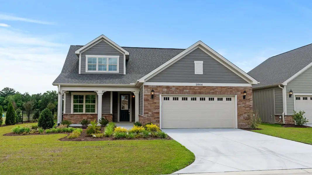 Front exterior of a new home in Courtyards by Carrell, Ocean Isle Beach, NC, highlighting curb appeal (Image 2). Front exterior of a new home in Courtyards by Carrell, Ocean Isle Beach, NC, highlighting curb appeal (Image 2).