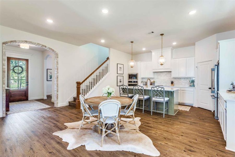 Dining area with dark hardwood / wood-style flooring