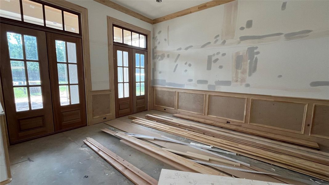 A progress photo in August 2025 showing the custom millwork being installed in the Library. Custom millwork throughout.