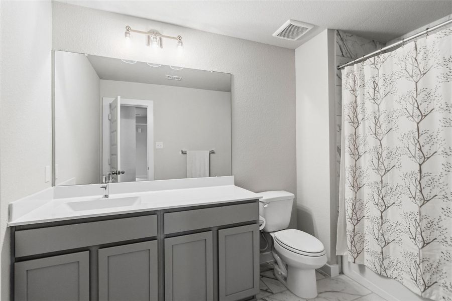 Designed with both style and functionality in mind, your secondary bath includes a spacious vanity, ample storage, and a tub/shower combination with designer tile finishes.