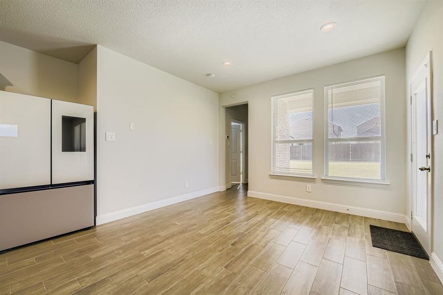 Unfurnished living room with light wood-style floors and recessed lighting Unfurnished living room with light wood-style floors and recessed lighting