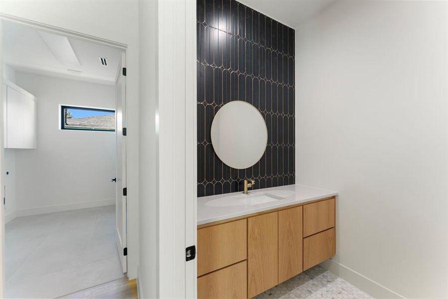 Half bath with vanity and light tile patterned flooring Half bath with vanity and light tile patterned flooring