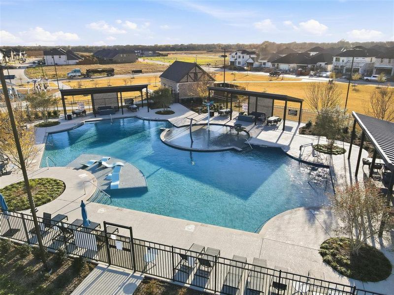 Community pool with a patio and a residential view