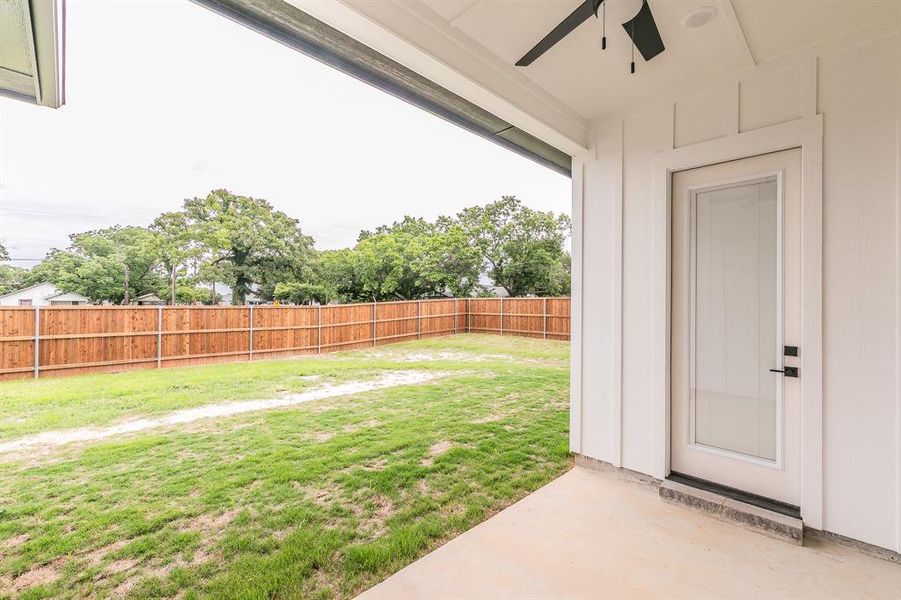 View of yard with a ceiling fan and a patio area View of yard with a ceiling fan and a patio area