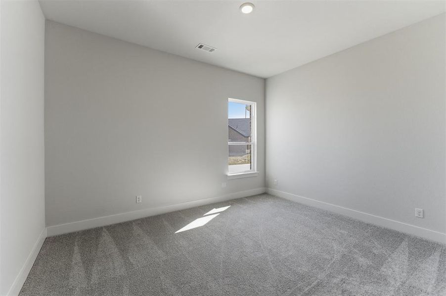 Unfurnished room with light colored carpet and baseboards Unfurnished room with light colored carpet and baseboards