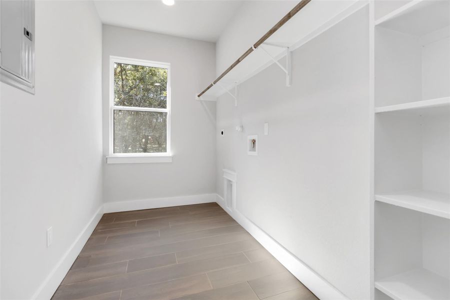 Laundry room with built-in shelving