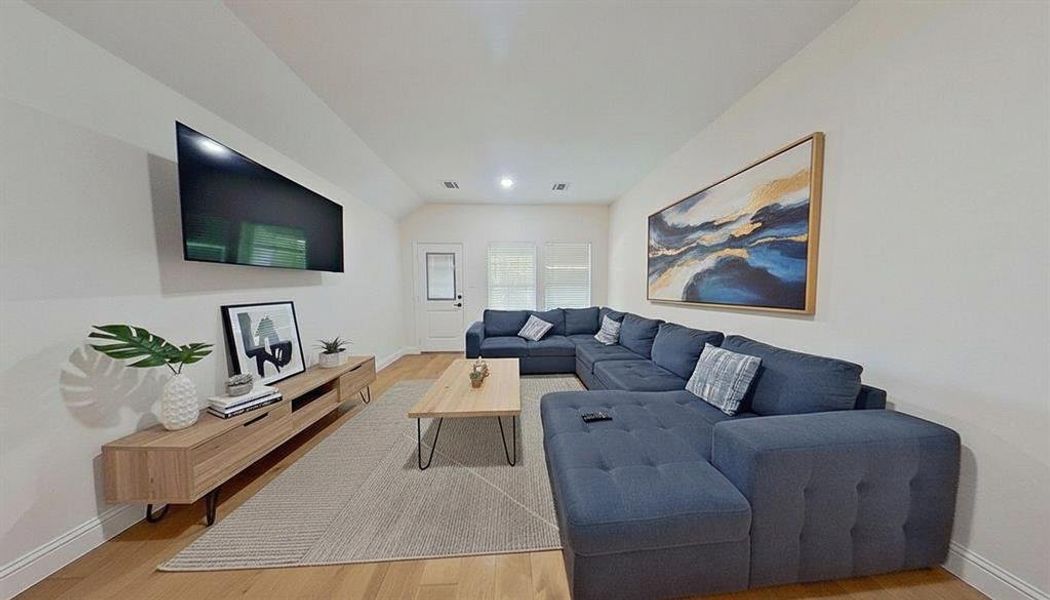 Living room featuring baseboards and light wood-style floors