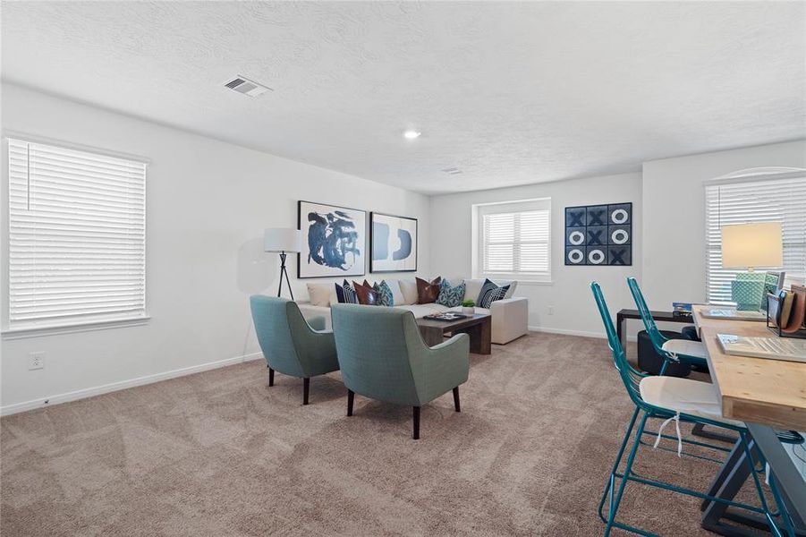 Come upstairs and enjoy a day of leisure in this fabulous game room/media room!!! This is the perfect hangout spot or adult game room, this space features plush carpet, high vaulted ceiling, recessed lighting, custom paint, and plenty of windows with natural light coming in.