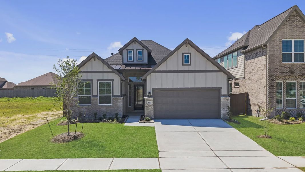 Front exterior of a new home in Blue Heron, Mont Belvieu, TX, highlighting curb appeal (Image 1). Front exterior of a new home in Blue Heron, Mont Belvieu, TX, highlighting curb appeal (Image 1).